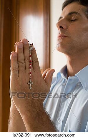 Man praying with rosary View Large Photo Image Stock Image - Man praying with rosary. Fotosearch