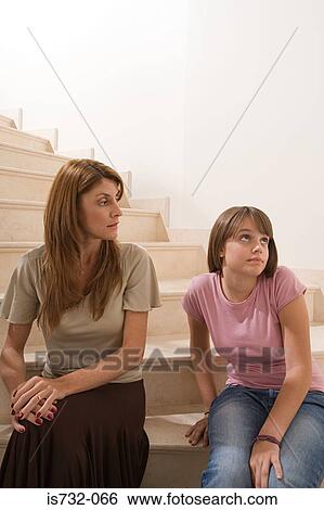 Stock Photograph - Mother and daughter sitting on stairs. Fotosearch
