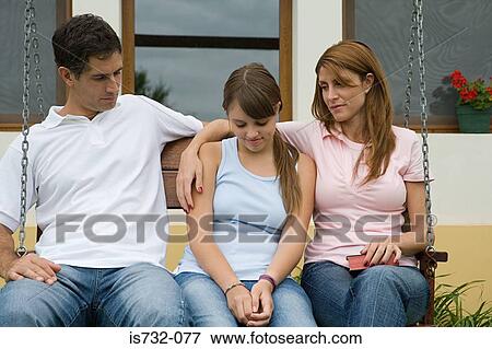 Stock Photo - Parents comforting daughter. Fotosearch