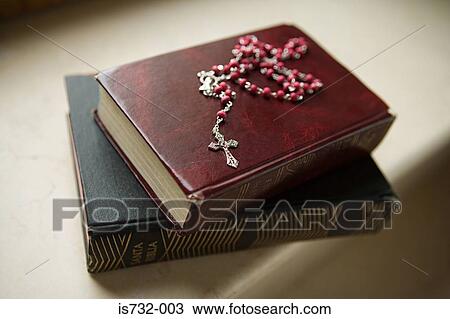 Rosary on bibles View Large Photo Image Stock Image - Rosary on bibles. Fotosearch