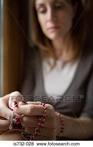 Woman holding rosary View Large Photo Image Stock Photo - Woman holding rosary. Fotosearch