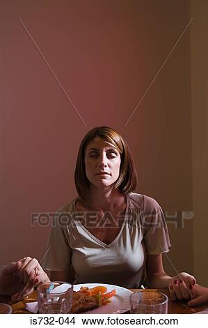 Picture - Woman saying grace. Fotosearch