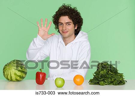 Young man with fruit and vegetables View Large Photo Image Stock Image - Young man with fruit and vegetables. Fotosearch