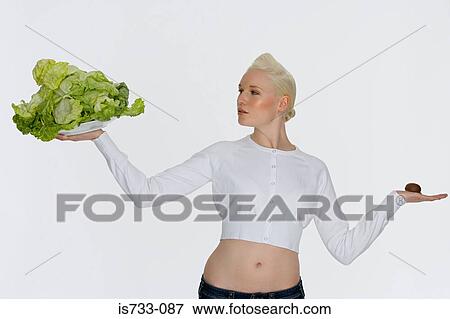 Young woman choosing View Large Photo Image Stock Photo - Young woman choosing. Fotosearch