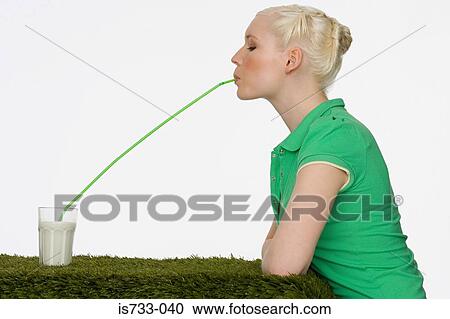 Young woman drinking milk View Large Photo Image Stock Image - Young woman drinking milk. Fotosearch