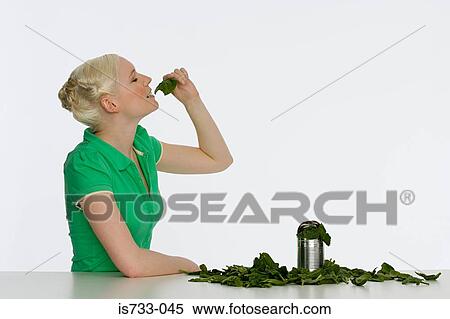 Young woman eating spinach View Large Photo Image Stock Photography - Young woman eating spinach. Fotosearch