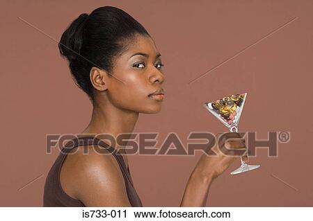 Young woman holding a cocktail glass full of vitamins View Large Photo Image Stock Image - Young woman holding a cocktail glass full of vitamins. Fotosearch