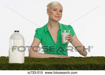 Stock Photography - Young woman holding a glass of milk. Fotosearch