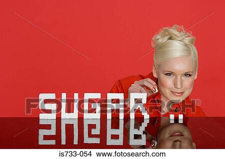 Young woman holding a sugar lump View Large Photo Image Picture - Young woman holding a sugar lump. Fotosearch