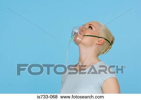 Young woman wearing an oxygen mask View Large Photo Image Stock Photo - Young woman wearing an oxygen mask. Fotosearch