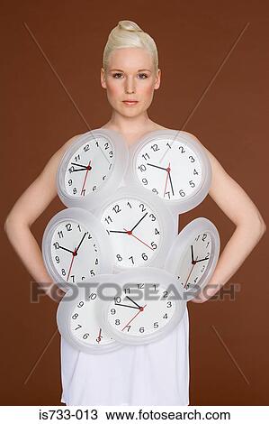 Young woman wearing clocks View Large Photo Image Stock Image - Young woman wearing clocks. Fotosearch