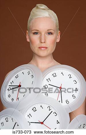 Young woman wearing clocks View Large Photo Image Stock Image - Young woman wearing clocks. Fotosearch