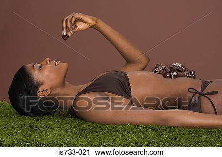 Young woman with chocolate on her stomach View Large Photo Image Stock Image - Young woman with chocolate on her stomach. Fotosearch