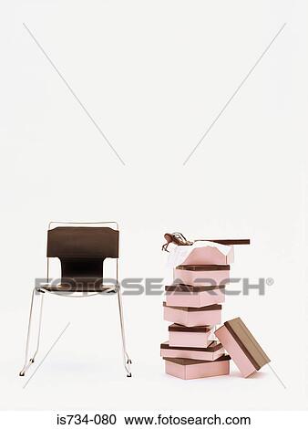Stock Image - Chair and pile of shoeboxes. Fotosearch