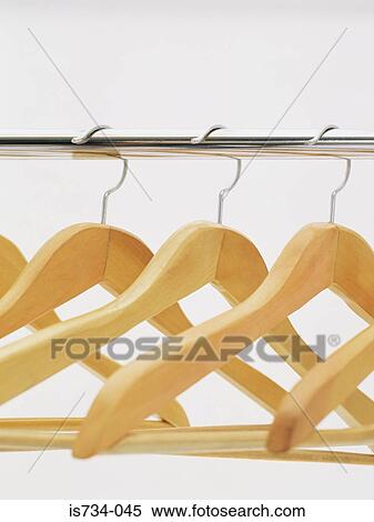 Coathangers on clothes rail View Large Photo Image Stock Photography - Coathangers on clothes rail. Fotosearch