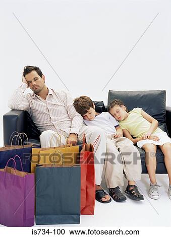 Stock Image - Father and children bored of shopping. Fotosearch