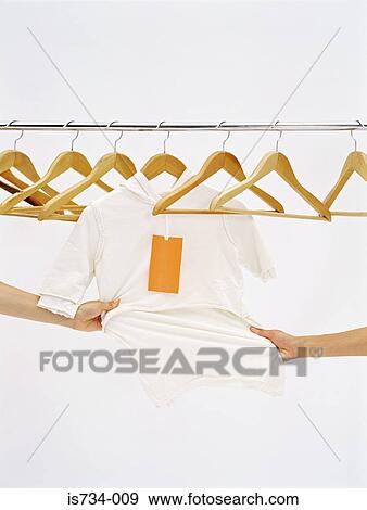 Stock Photo - People pulling the same top. Fotosearch