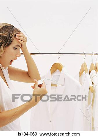 Woman shocked at price in clothes shop View Large Photo Image Stock Photo - Woman shocked at price in clothes shop. Fotosearch