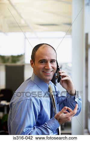 Businessman using a cellular telephone View Large Photo Image Stock Image - Businessman using a cellular telephone. Fotosearch
