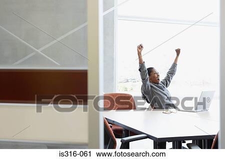 Stock Image - Businesswoman celebrating. Fotosearch