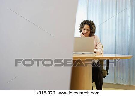 Stock Photo - Female office worker using a laptop computer. Fotosearch
