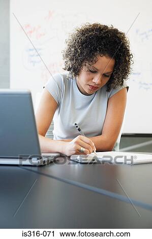 Female office worker writing View Large Photo Image Stock Image - Female office worker writing . Fotosearch