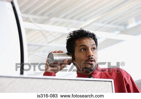 Man using a tin can telephone View Large Photo Image Stock Image - Man using a tin can telephone. Fotosearch