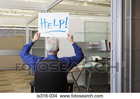 Office worker holding a help sign View Large Photo Image Picture - Office worker holding a help sign. Fotosearch