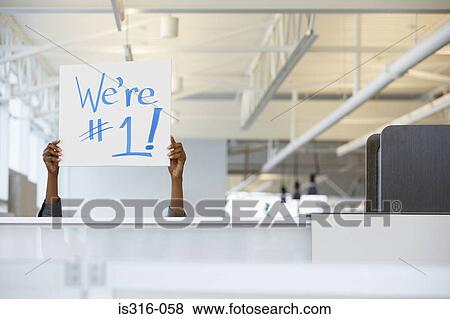 Stock Photo - Office worker holding a sign. Fotosearch