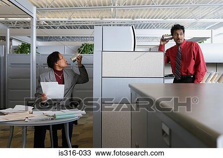 Two office workers using a tin can telephone View Large Photo Image Stock Image - Two office workers using a tin can telephone. Fotosearch