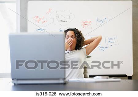 Woman yawning at computer View Large Photo Image Stock Photograph - Woman yawning at computer. Fotosearch