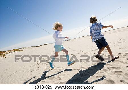 Boy and girl running on beach View Large Photo Image Stock Photography - Boy and girl running on beach. Fotosearch