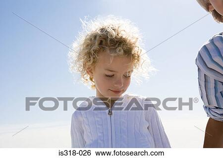 Girl and boy against blue sky View Large Photo Image Stock Photograph - Girl and boy against blue sky. Fotosearch