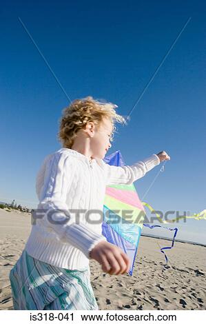 Girl flying kite on beach View Large Photo Image Stock Image - Girl flying kite on beach. Fotosearch