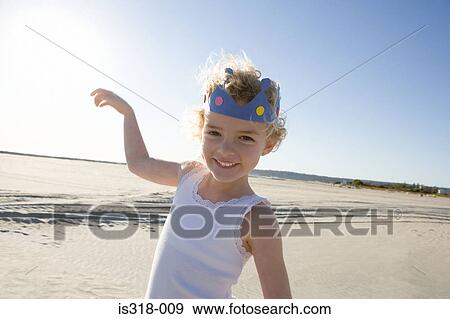 Stock Photo - Girl wearing crown on beach. Fotosearch