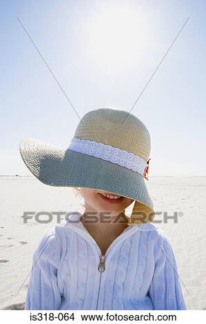 Girl wearing straw hat posing on beach View Large Photo Image Picture - Girl wearing straw hat posing on beach. Fotosearch