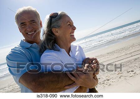 Senior couple embracing on beach View Large Photo Image Stock Image - Senior couple embracing on beach. Fotosearch