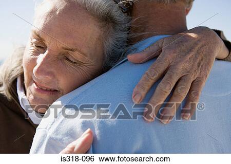 Senior couple embracing on beach View Large Photo Image Stock Photograph - Senior couple embracing on beach. Fotosearch