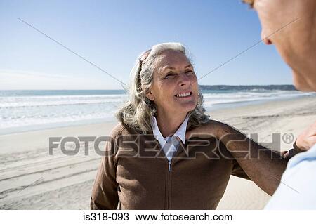 Stock Image - Senior couple on beach. Fotosearch