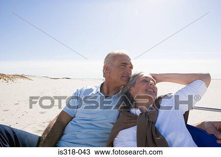 Senior couple relaxing on beach View Large Photo Image Stock Image - Senior couple relaxing on beach. Fotosearch