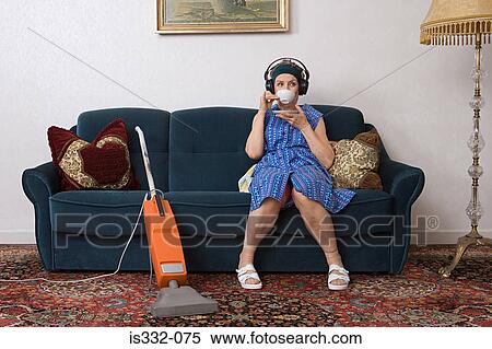 Stock Photography - Housewife having a cup of tea. Fotosearch