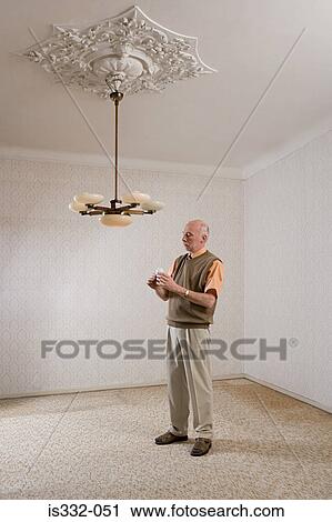 Man about to change a lightbulb View Large Photo Image Stock Image - Man about to change a lightbulb. Fotosearch