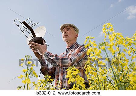 Man in a field with an aerial View Large Photo Image Stock Image - Man in a field with an aerial. Fotosearch