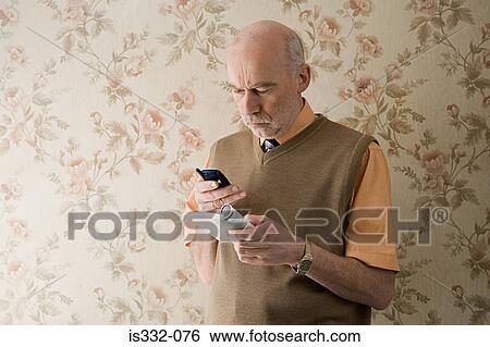 Man with cellphone looking confused View Large Photo Image Stock Photograph - Man with cellphone looking confused. Fotosearch
