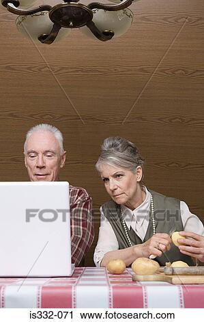Man with laptop and wife with potatoes View Large Photo Image Stock Image - Man with laptop and wife with potatoes. Fotosearch