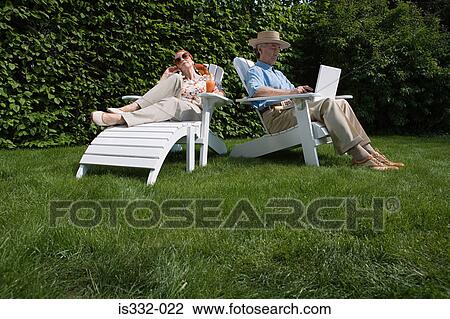 Stock Image - Senior couple in the garden. Fotosearch