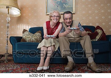 Senior couple playing video game View Large Photo Image Stock Image - Senior couple playing video game. Fotosearch