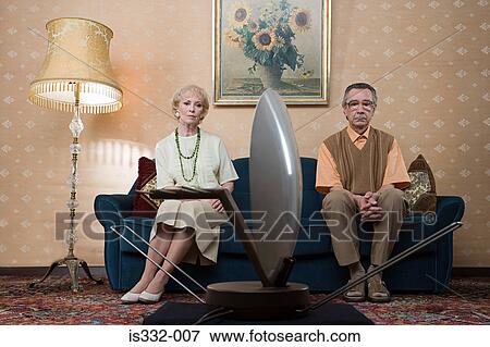 Stock Photo - Senior couple watching television. Fotosearch
