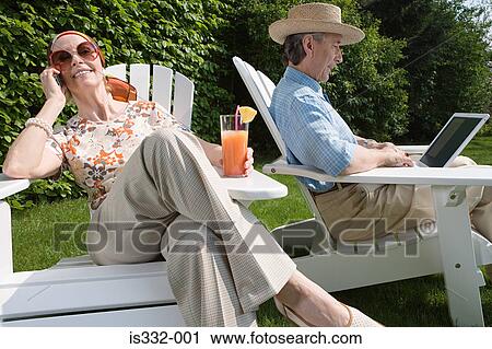 Senior couple with cellphone and laptop in the garden View Large Photo Image Stock Image - Senior couple with cellphone and laptop in the garden. Fotosearch