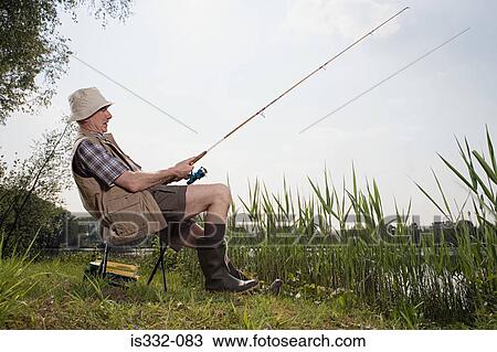 Stock Image - Senior man fishing. Fotosearch